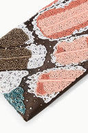 MUSE clutch close-up: brown base with peach, white, and teal beaded butterfly design