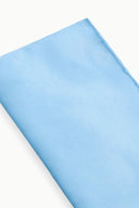 Light blue clutch fabric close-up with smooth satin-like finish