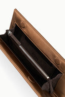 Tan leather clutch bag interior with zip pocket and drawstring pouch.
