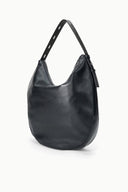 Black hobo bag angled view with top handles and side zip detail