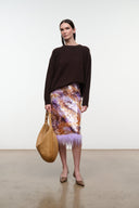 Levi cashew hobo bag with zip-top, carried on a curved shoulder strap