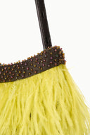 Detail of yellow fringe mini bag with dark beaded edge and espresso brown strap stitching.