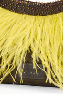 Close-up of yellow fringe mini bag showing dark beaded trim and brown leather base.