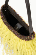 Inside view of yellow fringe mini bag with dark beaded trim and brown leather lining.