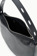 Black hobo bag showing zip pocket interior and perforated strap
