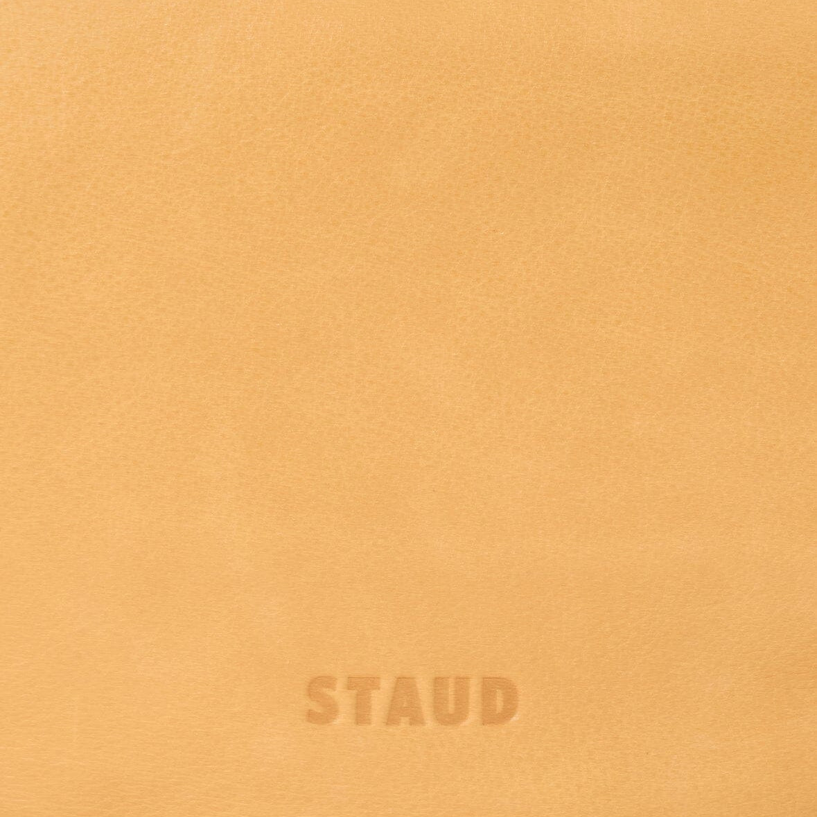 Levi cashew bag close-up of bottom logo stamp: STAUD