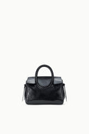 Maude mini carryall bag with structured body, curved handle, and dangling tassels