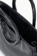 Maude mini carryall bag detail: croc-embossed strap with rounded flap and stitching