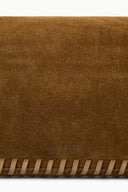 Cigar-brown suede handbag with fringed trim and subtle STAUD logo