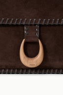 Espresso brown suede bag flap with stitched edge and wooden ring pull STAUD.