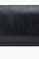Black leather shoulder bag close-up with embossed logo on front