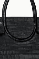 Black croc-embossed bag close-up of curved handle and stamped logo
