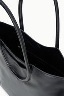 MAUDE black tote interior view with open top, two sections, and stitch detailing