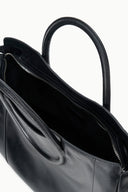 Maude black satchel interior view with zip top and lined compartment