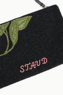 Black beaded pouch close-up with green floral beading and pink 'STAUD' text