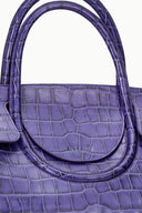 Purple croc-embossed carryall close-up of rolled handle and front panel