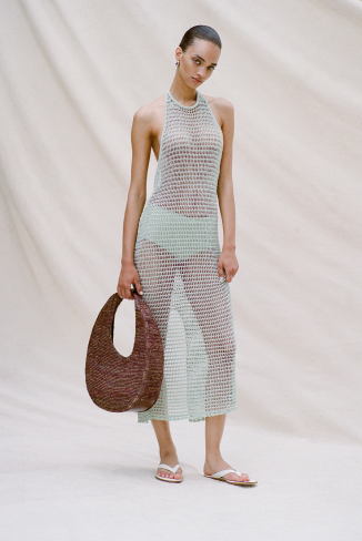 woman holding a raffia handbag