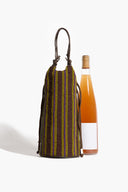 Beaded wine bottle bag with vertical multicolor stripes holding a glass bottle