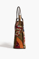 Multicolor beaded wine bottle bag angled view with drawstring top and braided handles