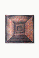 Square silk scarf with concentric geometric maze pattern in orange, blue, black