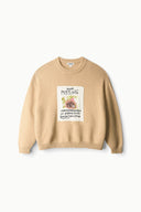 Beige knit sweater with square 'MISSING' graphic patch, ribbed crewneck and hem