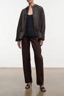 Hooded leather jacket in dark earth brown, front zip, drawstring details, side pockets.