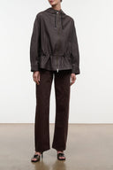 Hooded leather jacket with front zip and ruched hem; drawstring at hood.