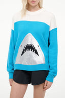 White and blue crewneck sweater with shark graphic