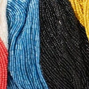 Close-up beaded wave stripes in blue, black, red, and yellow