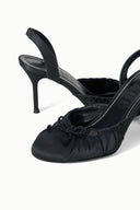 Black slingback high-heel pump with ruched vamp and tied bow, stiletto heel