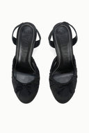 Pair of black slingback high-heel pumps showing open slingback straps and stiletto heel
