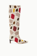 Tall suede patchwork boot with cream base and red, brown, and yellow heart shapes