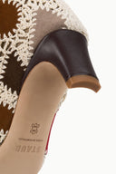 Close-up of suede patchwork boot heel and side panel with dark leather heel cap