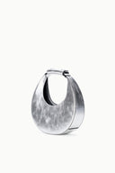 Silver crescent bag with black-lined interior and top snap closure