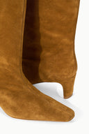 Tan mid-calf suede boot with pointed toe and stacked heel
