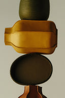<p>Leather decor introduces depth through form and material.</p>