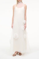 White sleeveless tulle dress with feather trim pom-poms at sides and hem