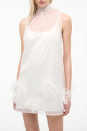 White mini dress with high neck, sleeveless sheer bodice, feather trim at hem