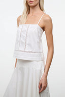 Ivory camisole top with thin spaghetti straps, square neckline, lace trim and vertical panels