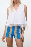 White sleeveless V-neck top with lace hem and crochet trim