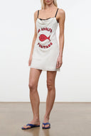 White silk mini dress with spaghetti straps, black trim, and DA ADOLFO Positano red fish print