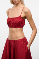 Red ruched bralette crop top with spaghetti straps and elastic neckline
