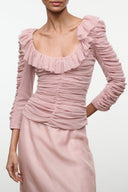 Blush pink ruched top with ruffled neckline and long gathered sleeves