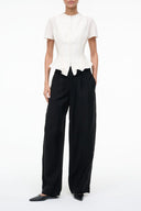 Ivory short-sleeve top with center-front zipper and peplum hem