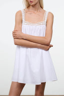 White sleeveless dress with lace-trim scoop neckline and lightweight babydoll skirt