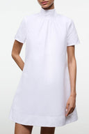 White mini dress with short sleeves, mock neck, and relaxed fit.