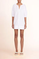 White mini shirt dress with V-neck, button front, and three-quarter puff sleeves