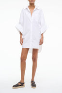 White shirt dress with button front, collar, and long sleeves with wide cuffs