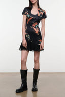 Black silk dress with short sleeves, scoop neck, and colorful floral bird print hem