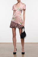 Pink silk dress with short sleeves, floral print and ruffled black hem